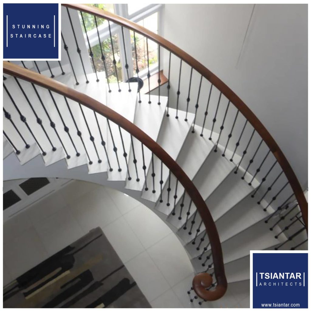 a spiral staircase in a house with a window.